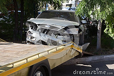 Car accident, head-on collision. Tow truck loads a wrecked car after an accident Stock Photo