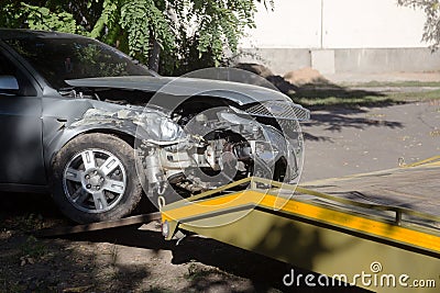 Car accident, head-on collision. Tow truck loads a wrecked car after an accident Stock Photo