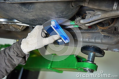 Car air-conditioner servicing. detection freon leak with ultraviolet lamp Stock Photo