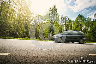 Car on asphalt road in beautiful spring day Stock Photo