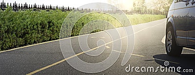 Car on the asphalt road on a summer day in the park. Panorama of transport on the road Stock Photo