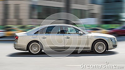 car Audi A8 2014 model fast moving on road in the city with blurred background Editorial Stock Photo