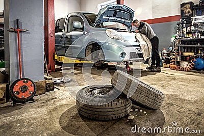 Car in automobile repair service center. Car with opened hood Stock Photo