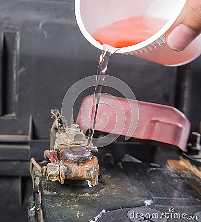 Car battery corrosion on terminal,Dirty battery terminals,Cleaning battery terminals by hot water. Stock Photo