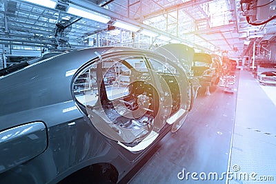 Car bodies are on Assembly line. Factory for production of cars in blue. Modern automotive industry. Blue tone Stock Photo