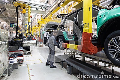 Car bodies are on assembly line. Factory for production of cars. Modern automotive industry. A car being checked before Stock Photo