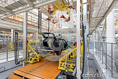 Car bodies are on assembly line. Factory for production of cars. Modern automotive industry. A car being checked before Editorial Stock Photo