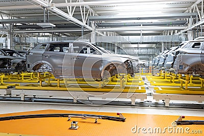 Car bodies are on assembly line. Factory for production of cars. Modern automotive industry Editorial Stock Photo