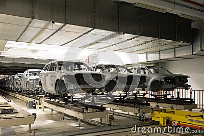 Car bodies are on assembly line. Modern automotive industry. Automobile conveyor. Interior of factory of manufacturing Editorial Stock Photo