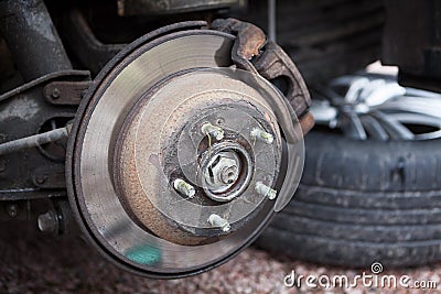 Car brake disk with removed wheel, inspection or changing to studded snow tyres Stock Photo