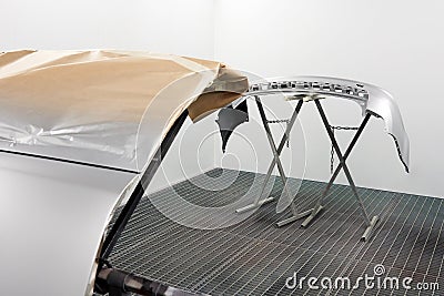 Car bumper after painting. Drying parts of the automobile in spray booth. Stock Photo