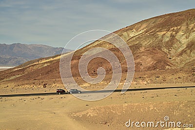 Car and camper in vast desert landscape Artist`s Drive road Death Valley Stock Photo