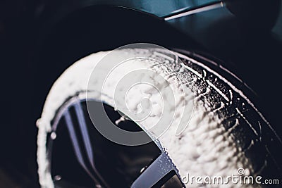Car Care or Car Detailing Process. Using black sponge to washing the tire. blacker rubber. Stock Photo