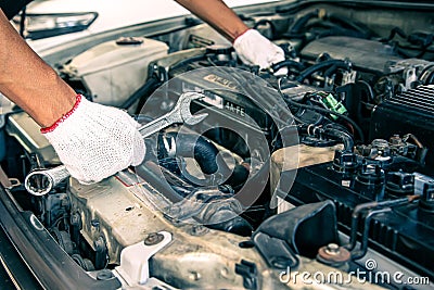 Close-up hand technician auto mechanic using the wrench to repairing change spare part car Stock Photo