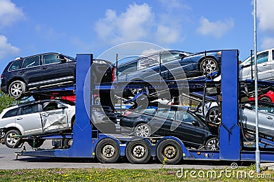 Car carrier trailer with used cars for sale on bunk platform Stock Photo