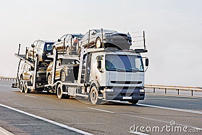 Car carrier truck deliver new auto batch to dealer Stock Photo