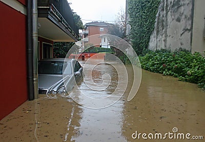 Car in the courtyard of the House submerged by flood mud Stock Photo