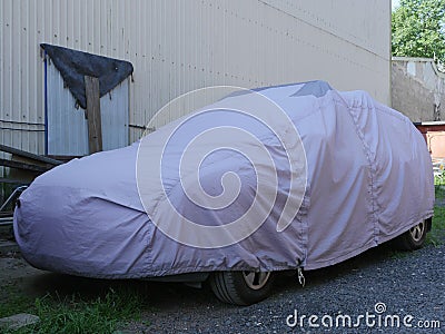 Car covered with a cover Stock Photo