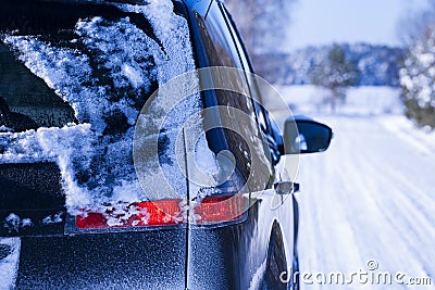 Car covered with snow on a dangerous road. Stock Photo
