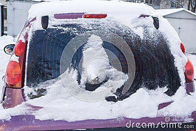 The car, covered with thick layer of snow. Negative consequence of heavy snowfalls. Close-up Stock Photo