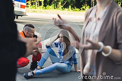 Car crash victim with paramedic helping her Stock Photo