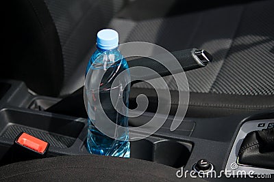 In the car in the cup holder there is a bottle of water, for the driver Stock Photo