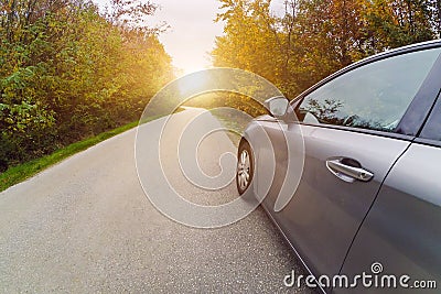 Car on the curvy road in nature in autumn Stock Photo