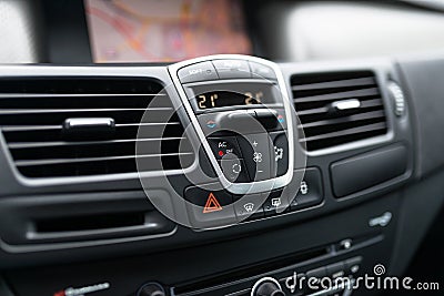 Car dashboard interior of modern car. Black cockpit with button and icon for air conditioner option, car window heating buttons an Stock Photo