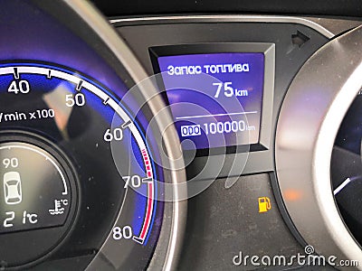 Car dashboard odometer showing 100,000 miles. lit the icon of the desired gasoline Stock Photo