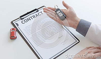 Car dealers or insurance managers cover and protect against damage and the risk of driving, Hold the car keys Stock Photo