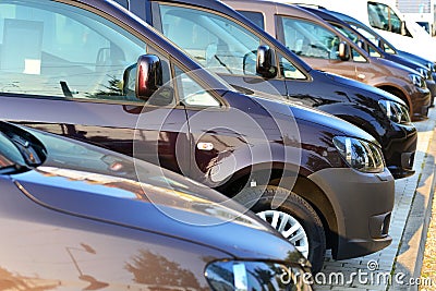 Car dealership - many vehicles parked for sale in a row Stock Photo