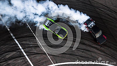 Car drift battle, Two car drifting battle on race track with smoke, Aerial view Stock Photo