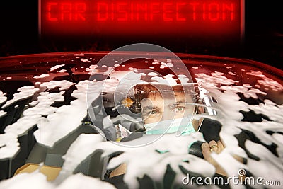 Driver with mask on face during car cleaning in disinfection station Stock Photo
