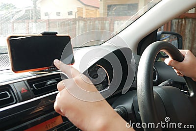 Car Driver With Smart Phone on Dashboard Stock Photo