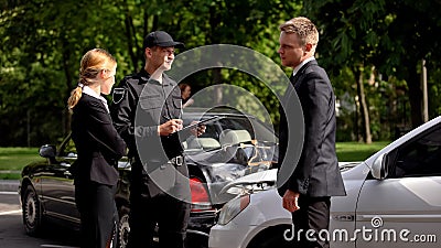 Car drivers and policeman near wrecked autos road, traffic collision, insurance Stock Photo