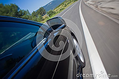 Car driving fast on a road Stock Photo