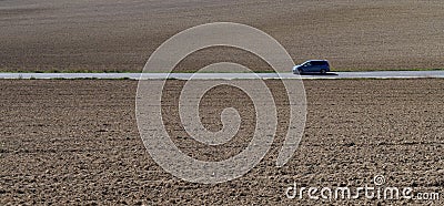Car driving through plowed fields, Navarra. Stock Photo