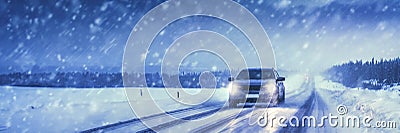 Car driving on winter road with snowfall Stock Photo