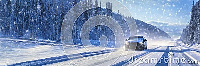 Car driving on winter road with snowfall Stock Photo