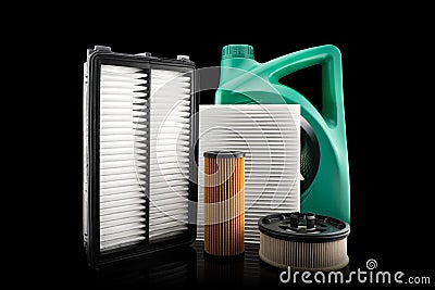 Car engine oil and filters isolated on black background. Car oil, air, fuel filters and motor oil in plastic can isolated. Quality Stock Photo