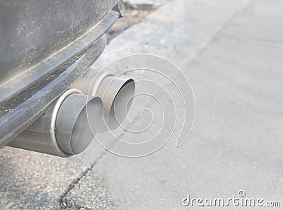 Car Exhaust With Two Smoking Tailpipes, Selected Focus Stock Photo