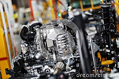An automobile internal combustion engine stands on the conveyor line of the production hall of an automobile plant. Stock Photo