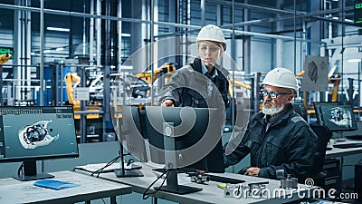 Car Factory Office: Female Manager Talks to Male Automotive Engineer Working on Computer. Automated Stock Photo