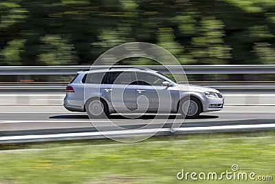 Car in fast motion with panning effect on highway Stock Photo