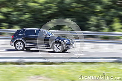 Car in fast motion with panning effect on highway Stock Photo