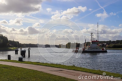 Car ferry boat crossing the Kiel canal in Germany on a sunny day. Editorial Stock Photo