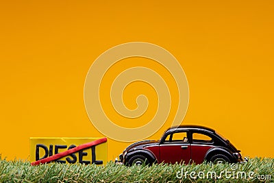 Chisinau 20.02.2020:A car figurine aligned to the right on grass next to a sign which has the word diesel cut Stock Photo