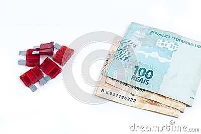 Car fuse. brazilian currency and pile of colorful electrical automotive fuses or circuit breakers Stock Photo