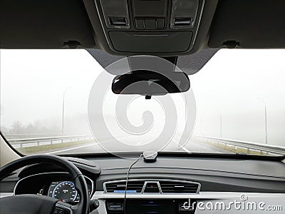 The car goes fast on the road in the fog, view from the passenger compartment Stock Photo