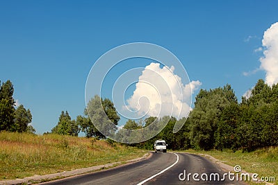 The car goes on highway in the middle of trees Stock Photo